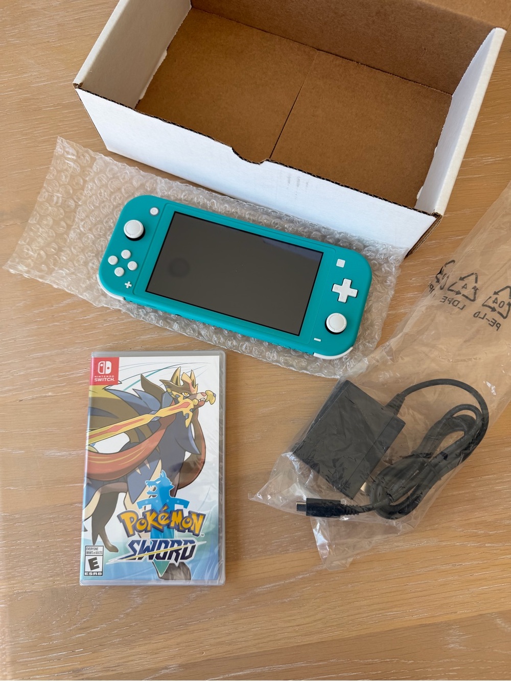 Nintendo Switch Lite Turquoise Handheld Console with Pokémon Sword Game